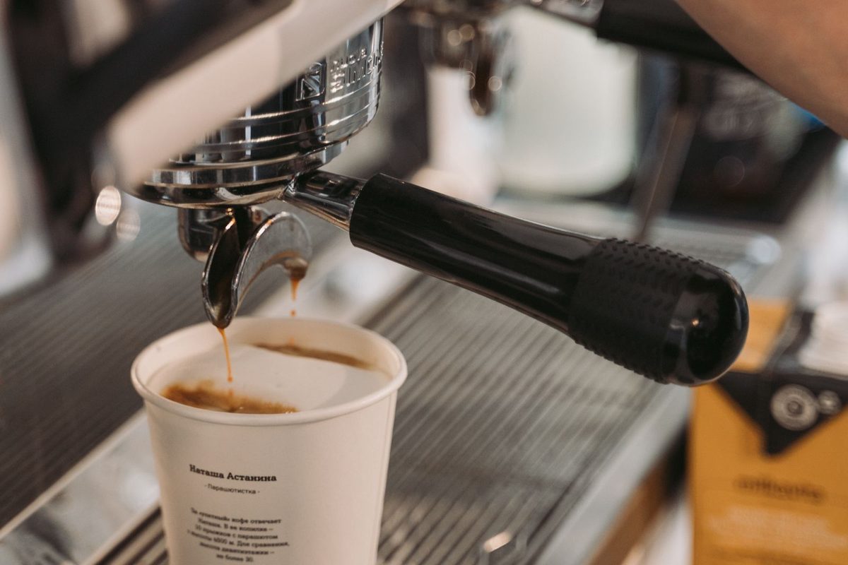 Barista pulling a shot of espresso on a cafe coffee machine